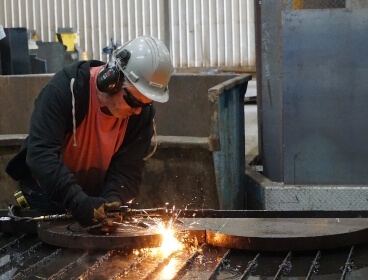 Worker cutting metals image